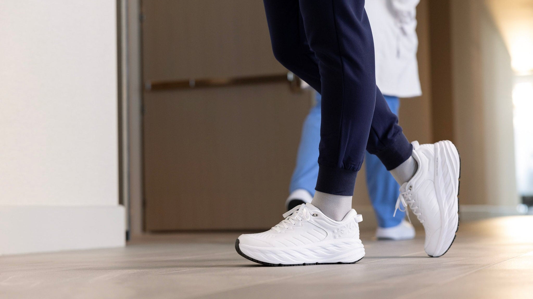 Nurse wearing White HOKA Bondi SR with scrubs