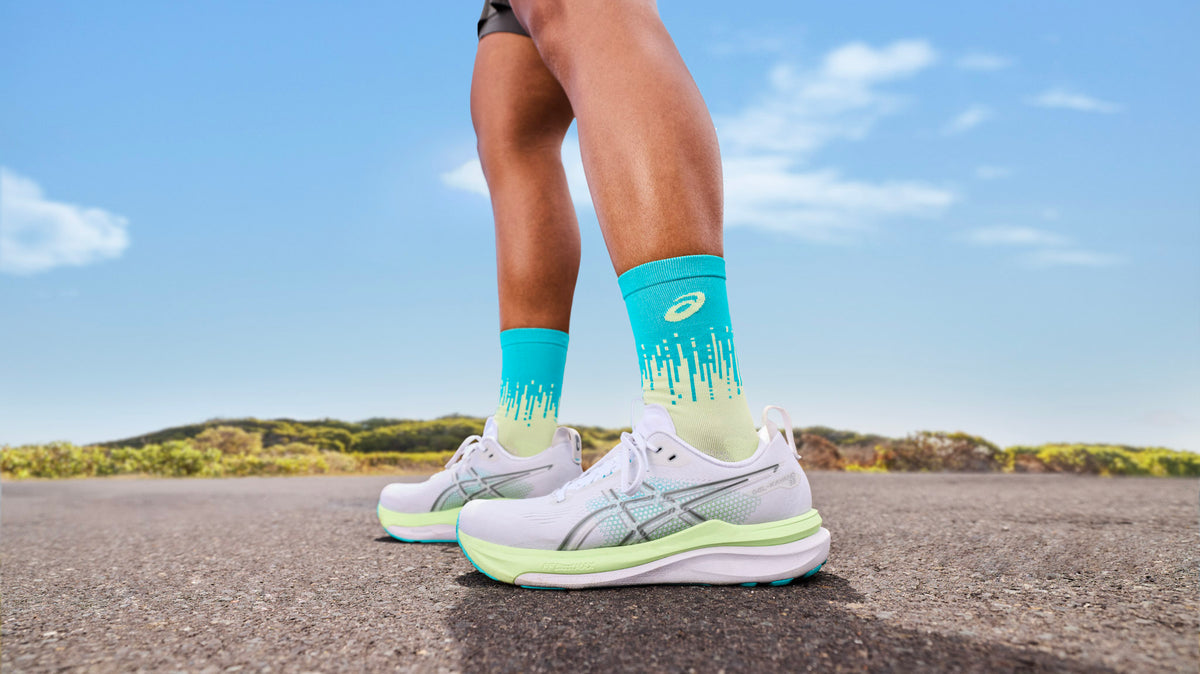 Neutral vs stability running shoes side-by-side on a bench, with callouts highlighting medial posting and sidewall rails.