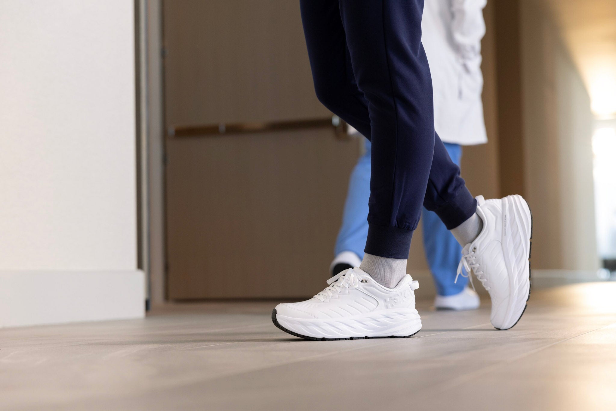 Nurse wearing White HOKA Bondi SR with scrubs