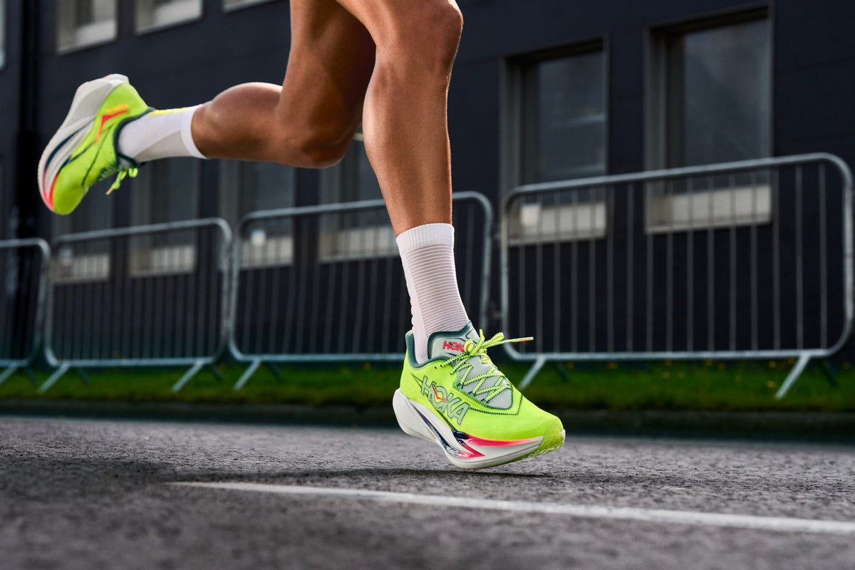 Runner lacing a shoe that shows a breathable mesh upper next to a knit and a film-overlay design for side-by-side comparison.