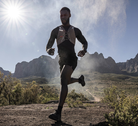Trail runner wearing a Garmin Fenix 9 Pro - Solar smartwatch in mountainous terrain