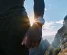 Garmin fēnix 9 Pro smartwatch worn on wrist outdoors in a mountain setting
