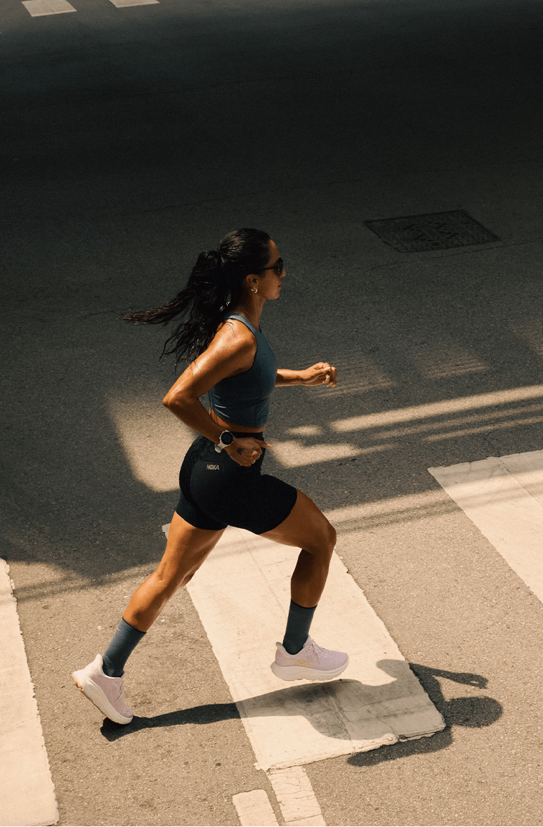 Semi bird eye view of a women jogging in the hoka bondi 9